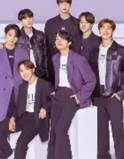 BTS members wearing elegant purple outfits in a stylish group portrait.